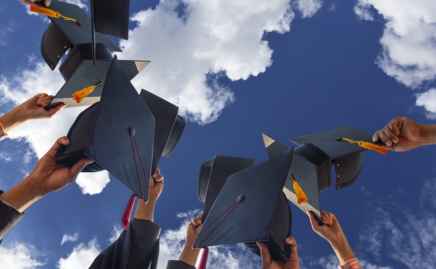 Graduation caps with view of blue skies